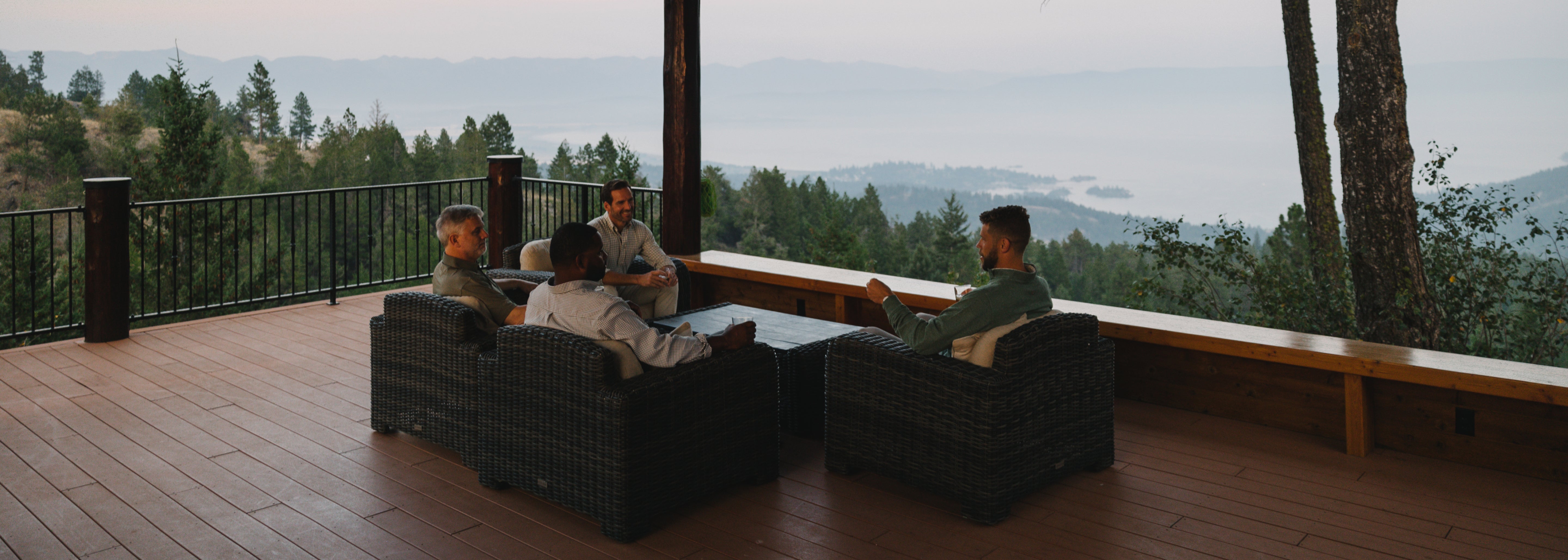 men sitting on a porch relaxing at a lodge wearing GenTeal mens clothing