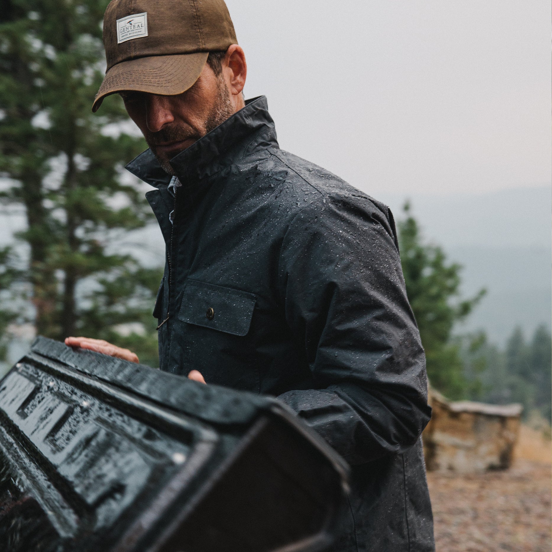 Man closing the back of his truck in GenTeal clothing and accessories.