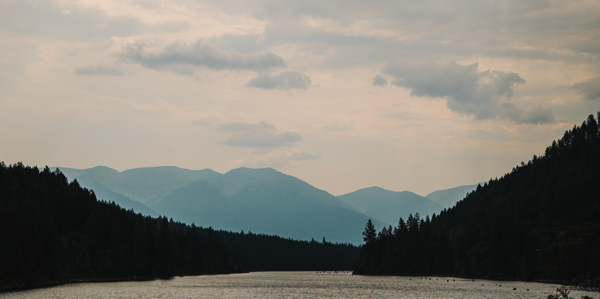 Landscape of a river with mountains in the back.