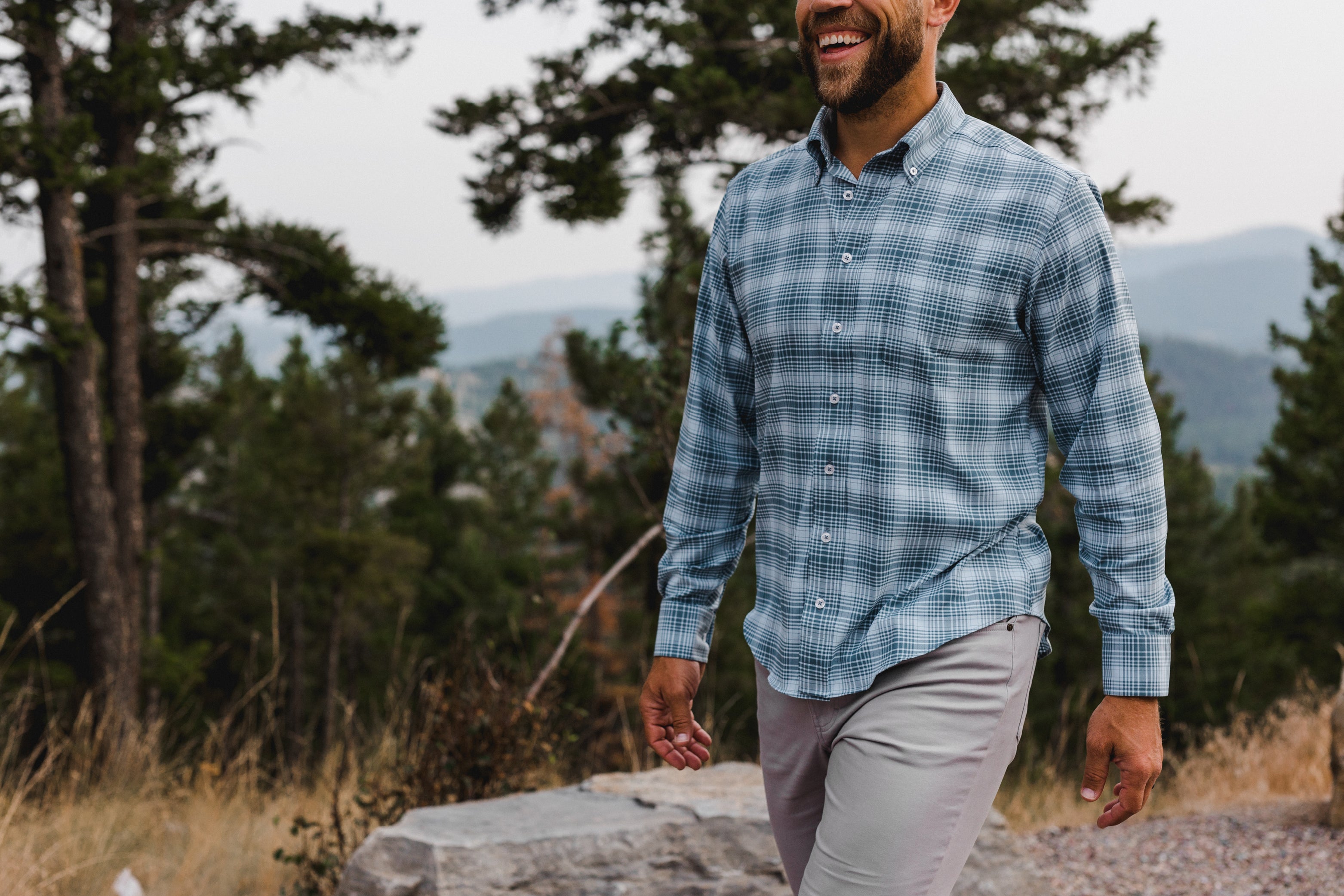 man smiling wearing a plaid button down shirt by GenTeal